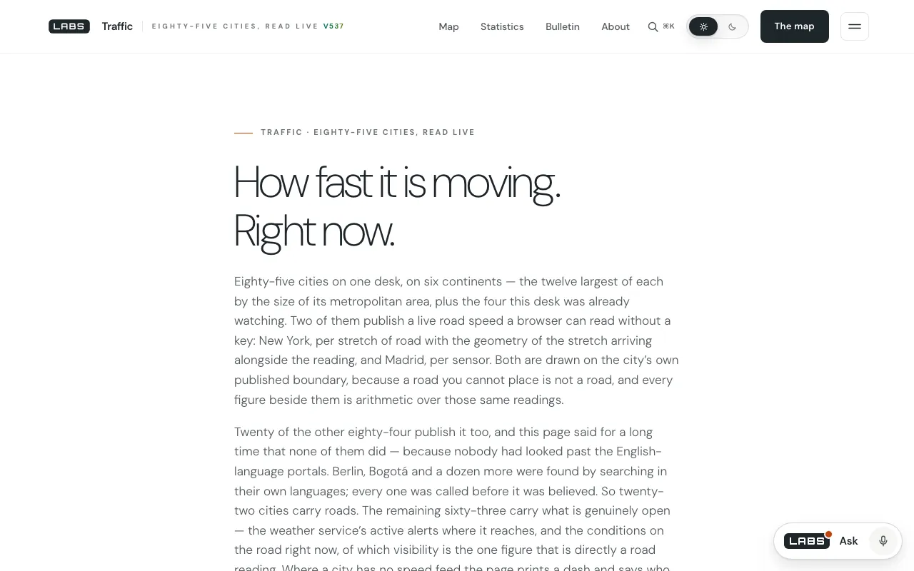 The Traffic desk on labs.llc: the headline “How fast it is moving. Right now.”, above paragraphs explaining that eighty-five cities are covered, that New York and Madrid publish live road speeds, and that twenty of the other cities publish speeds too, Berlin, Bogotá and a dozen more found by searching in their own languages.